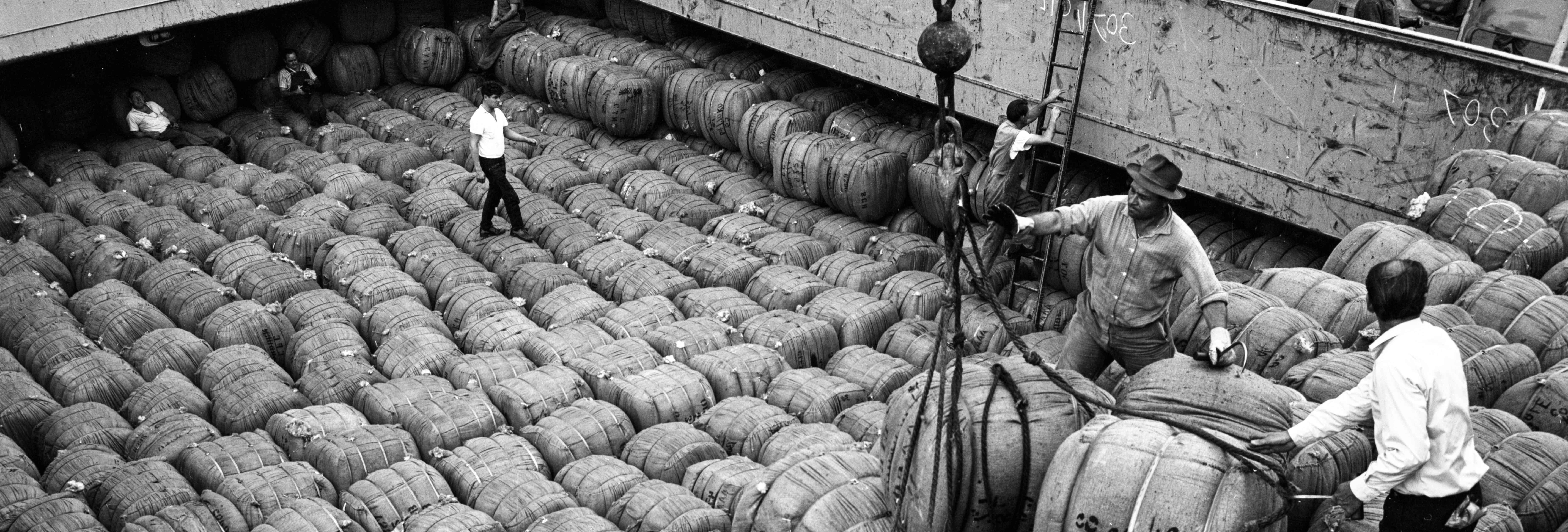 Black and white photo of crew unloading a ship