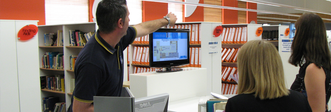 Reading Room of Public Record Office Victoria Support staff at help desk in archive