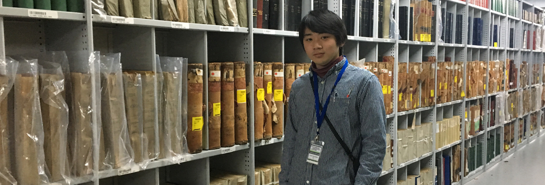 photo of a student standing in the archives repository