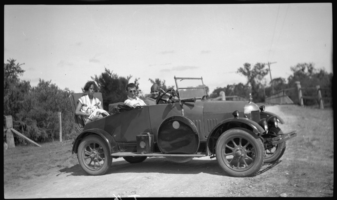 photo of a car with 3 people inside