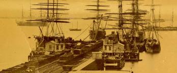 Image of tall ships docked at pier