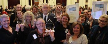 Photo of happy award winners with their trophies
